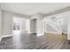 Open living room with wood-look floors and access to deck at 606 N Colorado Ave, Indianapolis, IN 46201