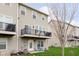 Back exterior view of townhome with balconies and a well-manicured lawn at 7282 Zanesville Rd, Carmel, IN 46033