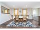 Inviting dining room featuring hardwood floors, stylish rug, and abundant natural light at 7282 Zanesville Rd, Carmel, IN 46033