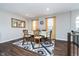Spacious dining room showcasing dark wood floors and natural light, perfect for gatherings at 7282 Zanesville Rd, Carmel, IN 46033