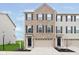 Charming brick front exterior of townhome with attached garage and well-manicured lawn at 7282 Zanesville Rd, Carmel, IN 46033