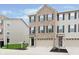 Charming brick front exterior of townhome with attached garage and well-manicured lawn at 7282 Zanesville Rd, Carmel, IN 46033