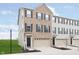 Charming brick front exterior of townhome with attached garage and well-manicured lawn at 7282 Zanesville Rd, Carmel, IN 46033