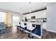Modern kitchen featuring white cabinets, a breakfast bar, and stainless steel appliances at 7282 Zanesville Rd, Carmel, IN 46033