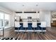 Stylish kitchen with island seating, stainless steel appliances, and contemporary lighting at 7282 Zanesville Rd, Carmel, IN 46033