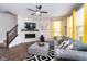 Comfortable living room featuring a tile fireplace surround, large sectional, and bright yellow curtains at 7282 Zanesville Rd, Carmel, IN 46033