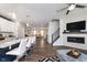 Open concept living area with a fireplace, modern ceiling fan, and bar seating at kitchen island at 7282 Zanesville Rd, Carmel, IN 46033