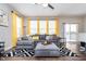 Bright living room with a large grey sofa, modern black and white rug, and sliding glass door to deck at 7282 Zanesville Rd, Carmel, IN 46033