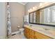 A bathroom featuring a double sink vanity with a large framed mirror and shower at 7290 Lockford Walk N, Avon, IN 46123
