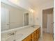 Bathroom features a double sink vanity, large mirror, and tile flooring at 7290 Lockford Walk N, Avon, IN 46123