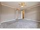 Comfortable bedroom featuring carpet, a ceiling fan, and multiple doorways for convenience at 7290 Lockford Walk N, Avon, IN 46123