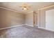 A spacious bedroom with plush carpet, ceiling fan, and white trim detail throughout at 7290 Lockford Walk N, Avon, IN 46123