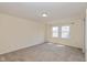 This cozy bedroom features plush carpeting and natural light from the bright window at 7290 Lockford Walk N, Avon, IN 46123