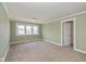 A spacious bedroom with plush carpet, three windows and white trim detail throughout at 7290 Lockford Walk N, Avon, IN 46123