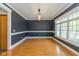 Formal dining room with elegant dark walls, white trim, hardwood floors, and a chandelier at 7290 Lockford Walk N, Avon, IN 46123