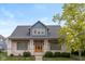 Charming home featuring a brick facade, stylish blue accents, and a well-manicured lawn at 7290 Lockford Walk N, Avon, IN 46123
