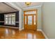 Inviting foyer with hardwood floors, natural light, and detailed woodwork around the front door at 7290 Lockford Walk N, Avon, IN 46123