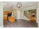 Open-concept kitchen and living area with hardwood floors, staircase, and fireplace at 7290 Lockford Walk N, Avon, IN 46123