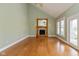 Spacious living room with a fireplace, large windows, hardwood floors, and neutral colors at 7290 Lockford Walk N, Avon, IN 46123