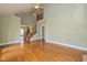 Open living room with hardwood floors, staircase, and bright, neutral color palette at 7290 Lockford Walk N, Avon, IN 46123