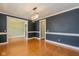 Spacious living room with hardwood floors, chair railing, and elegant dark walls at 7290 Lockford Walk N, Avon, IN 46123