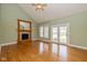 Inviting living room featuring a cozy fireplace, light-green walls, and access to outdoor living at 7290 Lockford Walk N, Avon, IN 46123