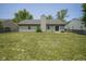 View of the backyard with a grassy lawn, patio area, and sliding glass doors leading into the home at 8391 Inland Dr, Avon, IN 46123