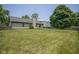 Spacious backyard with a lush green lawn, chimney, and fenced perimeter providing privacy at 8391 Inland Dr, Avon, IN 46123
