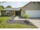 Charming single-story home with brick details, an attached two-car garage and a well-landscaped front entrance at 8391 Inland Dr, Avon, IN 46123