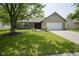 Inviting single-story home with a manicured lawn, brick details, and an attached two-car garage at 8391 Inland Dr, Avon, IN 46123
