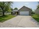 Well-maintained single-story home with an attached garage, brick facade, and a spacious driveway at 8391 Inland Dr, Avon, IN 46123