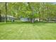 Backyard with well manicured lawn with a small custom-built house for a dog at 1127 Grant Cir, Cicero, IN 46034