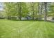 Expansive backyard featuring a well-maintained lawn and mature trees surrounding the charming home at 1127 Grant Cir, Cicero, IN 46034