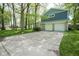 Inviting two-story home featuring a blue-gray exterior, stone accents, an attached two-car garage, and a wide concrete driveway at 1127 Grant Cir, Cicero, IN 46034
