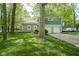 Charming two-story home with a combination of stone and blue siding, complemented by a well-manicured lawn and mature trees at 1127 Grant Cir, Cicero, IN 46034