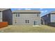 A charming backyard with vinyl siding, a sliding glass door, and a well-maintained lawn at 8131 Trailstay Dr, Camby, IN 46113