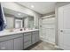 Bathroom featuring double sinks and a shower with sliding glass door at 8131 Trailstay Dr, Camby, IN 46113