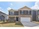 Two-story home featuring stone accents, a two-car garage, and well-maintained landscaping at 8131 Trailstay Dr, Camby, IN 46113