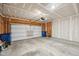 Unfinished garage featuring a large metal garage door with room for two cars at 8131 Trailstay Dr, Camby, IN 46113
