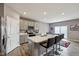 Kitchen with a large center island, stainless steel appliances, gray cabinets, and a walkout sliding glass door at 8131 Trailstay Dr, Camby, IN 46113
