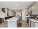 Spacious kitchen features a center island, stainless appliances, grey cabinets, and an adjacent staircase at 8131 Trailstay Dr, Camby, IN 46113