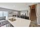 Kitchen island features double sinks and seating, connecting to the living area and staircase at 8131 Trailstay Dr, Camby, IN 46113