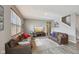Bright living room with large window, hardwood floors, neutral walls, and comfortable leather sofas at 8131 Trailstay Dr, Camby, IN 46113