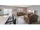 Open-concept living space with hardwood floors, a large window, and comfortable sofas with a kitchen at 8131 Trailstay Dr, Camby, IN 46113