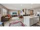 Open-concept living room and kitchen area with hardwood floors, two sofas, and modern appliances at 8131 Trailstay Dr, Camby, IN 46113