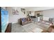 Open living space featuring hardwood floors, neutral walls, leather sofas, and kitchen island at 8131 Trailstay Dr, Camby, IN 46113