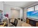 Living room area with television, window, desk, and office equipment at 8131 Trailstay Dr, Camby, IN 46113