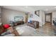 Cozy living room featuring hardwood floors, neutral walls, modern decor, and staircase at 8131 Trailstay Dr, Camby, IN 46113