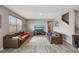 Inviting living room with hardwood floors, neutral paint, large windows, and comfortable leather sofas at 8131 Trailstay Dr, Camby, IN 46113