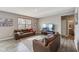 Spacious living room featuring hardwood floors, neutral walls, large window, and leather sofas at 8131 Trailstay Dr, Camby, IN 46113